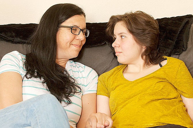 Laura Polanco and her daughter, Meredith Erck, comfort each other while recalling months of fighting Erck's brain tumor while she tried to complete her high school course work in Rapid City, South Dakota. Erck is six credits short of earning her Rapid City Central high school diploma, and although she will finish them over the summer, is not being allowed to participate in the graduation ceremony with her twin brother, Martin. 