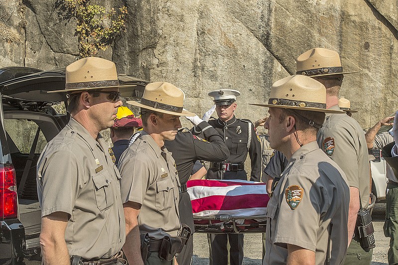 On Oct. 8, 2014, Yosemite National Park Rangers transfer the body of a Cal Fire pilot who was killed in an airplane crash in Yosemite National Park, California. An investigation into the 2014 fatal crash found the pilot was warned to avoid a hazardous tree to the right of his flight path before a wing struck trees to the left, according to a National Transportation Safety Board report released Wednesday.