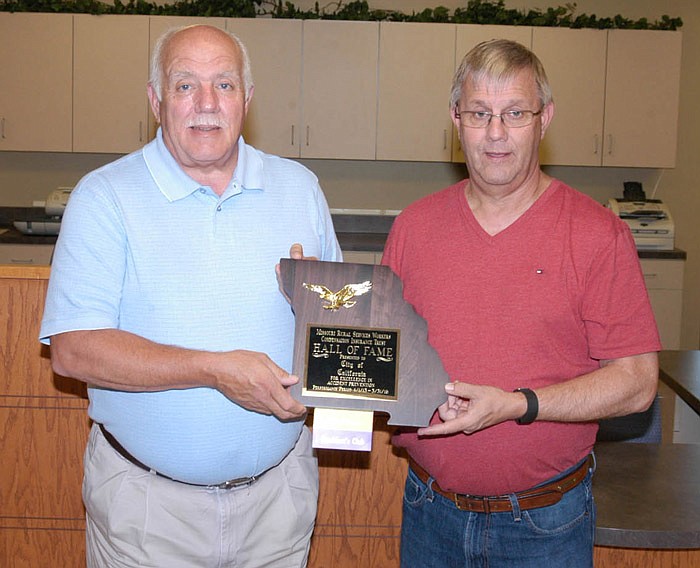 California City Clerk Brian Scrivner, left, and Mayor Norris Gerhart hold the Missouri Rural Services Workers Compensation Insurance Trust Hall of Fame award presented to the city recently. 
