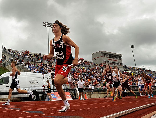 Jefferson City's Brendan Bena races into the turn after taking the baton from teammate Jackson Schwartz during the 4x800-meter relay at last year's Class 5 state track and field championships.