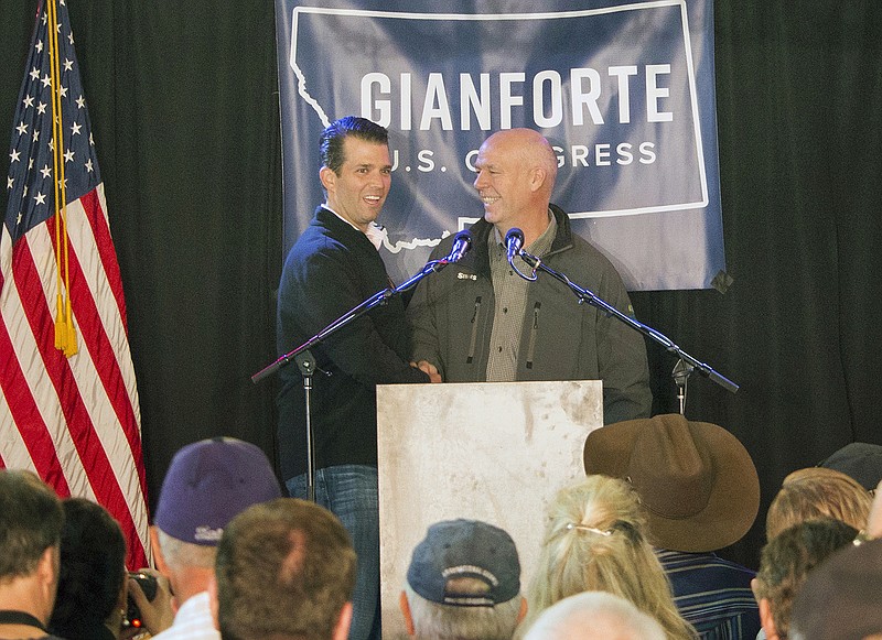 Republican Greg Gianforte, right, welcomes Donald Trump Jr. onto the stage May 11 at a rally in East Helena, Montana. Gianforte, charged with shoving a reporter to the ground on the eve of a special election kept a low profile Thursday, even as supporters prepared a hotel ballroom for a possible victory party.