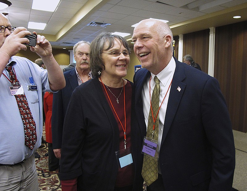 FILE - In this March 6, 2017, file photo, Greg Gianforte, right, receives congratulations from a supporter in Helena, Mont. Montana voters headed to the polls Thursday, May 25, 2017, to decide a nationally watched congressional election amid uncertainty in Washington over President Donald Trump's agenda and his handling of the country's affairs. Gianforte was elected despite being charged Wednesday with assault after witnesses said he grabbed a reporter by the neck and threw him to the ground.