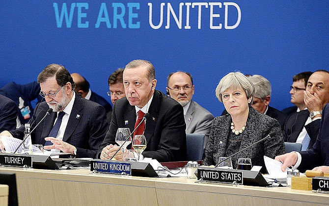 From left, Spanish Prime Minister Mariano Rajoy, Turkish President Recep Tayyip Erdogan and Britain's Prime Minister Theresa May take part in a working dinner meeting Thursday during the NATO summit of heads of state and government at the NATO headquarters in Brussels. U.S. President Donald Trump inaugurated the new headquarters during a ceremony Thursday.