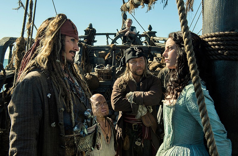 In this image released by Disney, Johnny Depp portrays Jack Sparrow, left, and Kaya Scodelario portrays Carina Smyth, right, in a scene from "Pirates of the Caribbean: Dead Men Tell No Tales." 