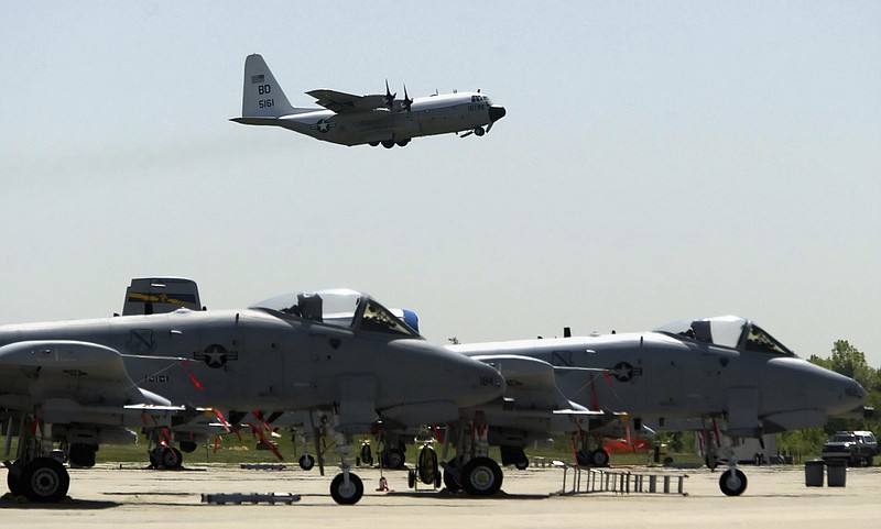 In this May 13, 2004 file photo, A-10's from the 111th Fighter Wing are seen in the foreground as a U.S. Navy C-130 takes off from N.A.S. J.R.B. Willow Grove in Willow Grove Pa. The Warthog is sitting pretty. Once on the brink of forced retirement, the A-10 attack plane with the ungainly shape and odd nickname has been given new life, spared by Air Force leaders who have reversed the Obama administration's view of the plane as an unaffordable extra in what had been a time of tight budgets.  