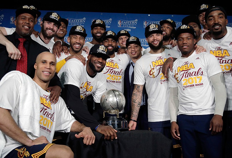 The Cleveland Cavaliers pose with their trophy after winning Game 5 of the NBA basketball Eastern Conference finals against the Boston Celtics 135-102, on Thursday, May 25, 2017, in Boston.