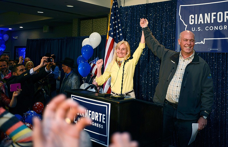 Greg Gianforte, right, and wife Susan, center, celebrate his win over Rob Quist for the open congressional seat at the Hilton Garden Inn Thursday night, May 25, 2017, in Bozeman, Mont. Gianforte, a technology entrepreneur, defeated Democrat Quist to continue the GOP's two-decade stronghold on the congressional seat. 