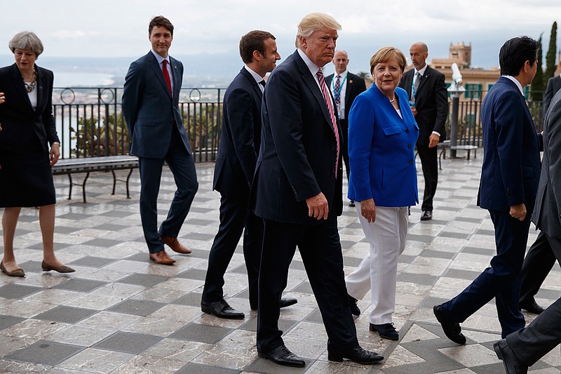 President Donald Trump takes a walking tour with G7 leaders, Friday, May 26, 2017, in Taormina, Italy. From left, British Prime Minister Theresa May, Canadian Prime Minister Justin Trudeau, French President Emmanuel Macron, Trump, German Chancellor Angela Merkel, and Japanese Prime Minister Shinzo Abe. 