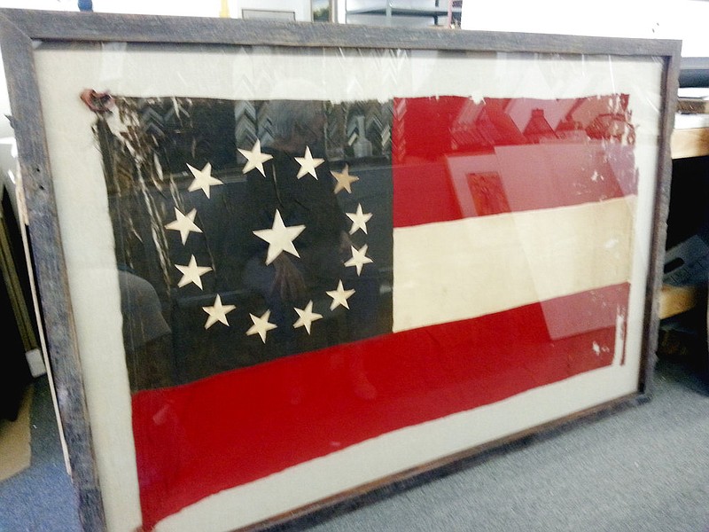 This July 2016 photo provided by the Judith A. Schmidt shows a Confederate flag after archival framing was completed in St. Louis. The Louisiana Area Historical Museum in the small Mississippi River town of Louisiana, Mo. unveils the donated, framed 34-inch-by-58-inch flag Saturday, May 27, 2017, to coincide with the museum's 25th anniversary celebration.