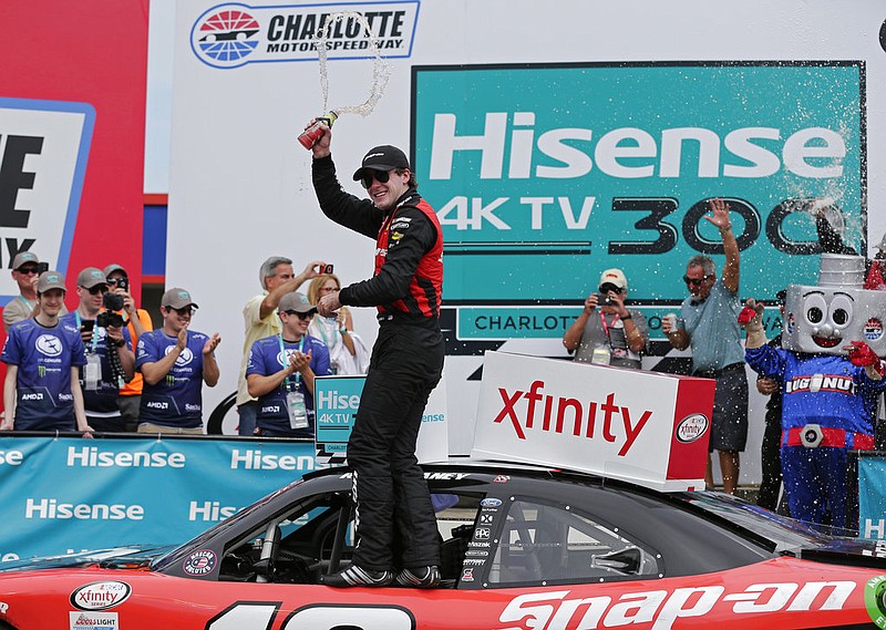 Ryan Blaney celebrates in Victory Lane after winning the NASCAR Xfinity series auto race at Charlotte Motor Speedway in Concord, N.C., Saturday, May 27, 2017.