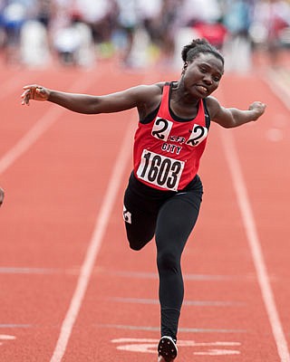 Naomi Kerkula of Jefferson City leans at the finish line of the 100-meter dash Friday in the state track and field championships at Adkins Stadium.