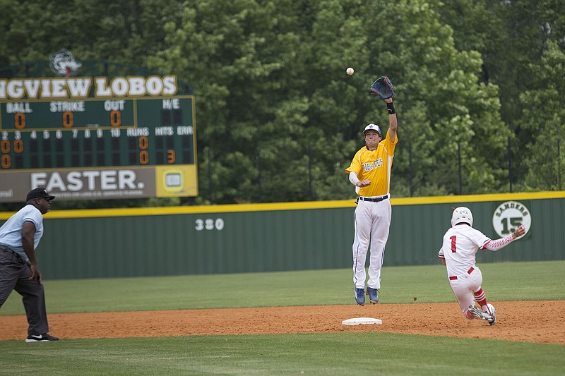 James Bowie second baseman Logan Graham leaps in an attempt to make the catch as Groveton's Chance Coker sprints towards the bag in the third inning of a game Saturday in Longview, Texas.