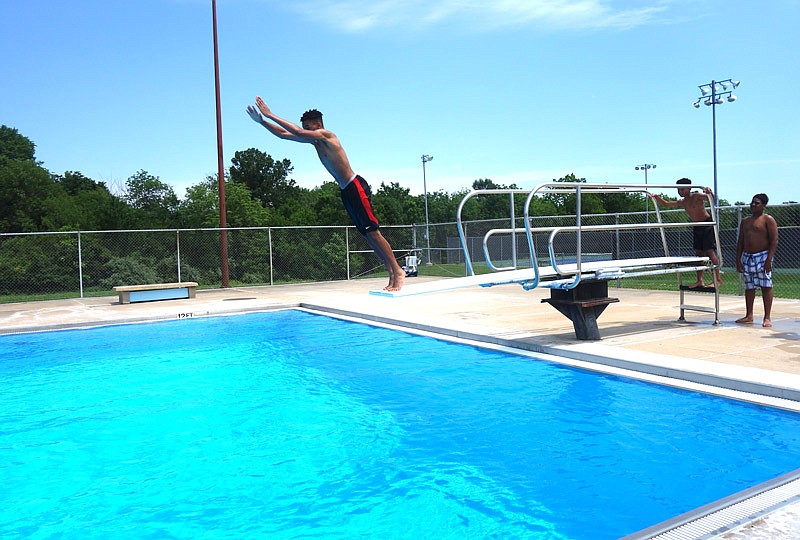 Etan Robinson dives into Oestreich Municipal Pool. The pool, located next to Fulton High School, opened for the summer on Saturday.