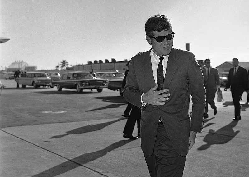 In this Dec. 18, 1961 file photo, President John F. Kennedy heads for Washington after an overnight stopover in West Palm Beach, Fla., where he rested after his Latin American tour due to a heavy cold. Monday, May 29, 2017 marks the 100-year anniversary of his birth.