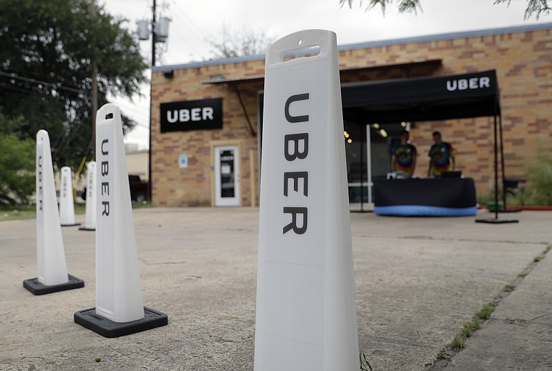In this Friday, May 26, 2017 photo, workers set up in a tent to welcome drivers back to the Uber offices in Austin, Texas. Uber and Lyft, the ride-hailing company giants who left Texas's capital city in a huff a year ago over local fingerprint requirements for drivers, are set to return after state lawmakers stepped in. 