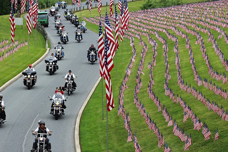 In this May 27, 2017 photo, motorcyclists ride into Indian town Gap National Cemetery in Annville, Pa., for a Memorial Day weekend program. While millions of Americans celebrate the long Memorial Day weekend as the unofficial start of summer, some veterans and loved ones of fallen military members wish the holiday that honors the nation's war dead would command more respect.