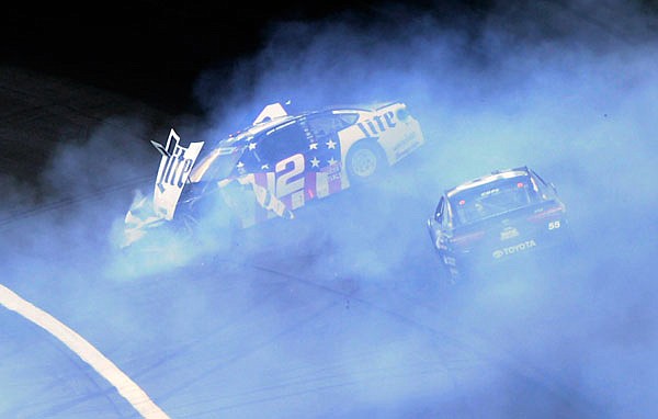 Brad Keselowski (2) crashes as Derrike Cope (55) tries to drive past during Sunday night;s NASCAR Cup series race at Charlotte Motor Speedway in Concord, N.C.