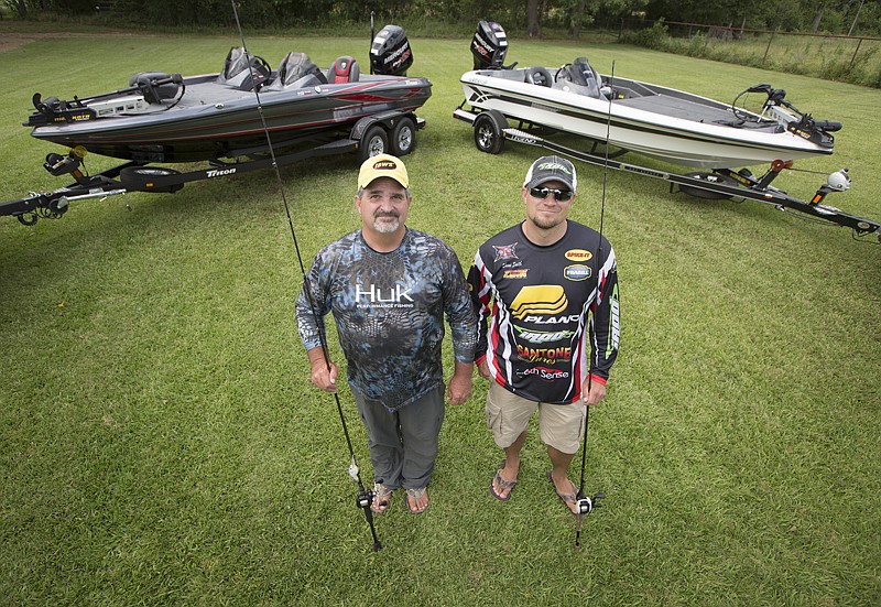 Chad Williams and Shane Smith pose in front of the new bass boats they recently received for winning bass tournaments. Williams won the Sealy Big Bass Splash, and Smith placed second at the Legend of Lake Fort Bass Tournament.