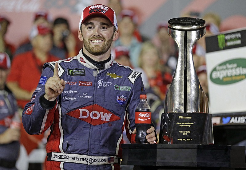 Austin Dillon poses with the trophy in Victory Lane after winning the NASCAR Cup series auto race Monday at Charlotte Motor Speedway in Concord, N.C.