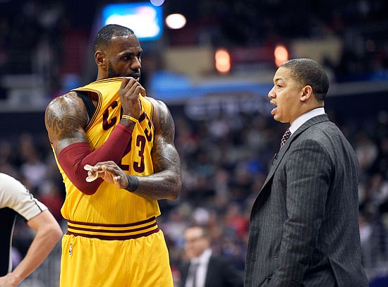Cavaliers forward LeBron James talks with head coach Tyronn Lue during the first half of a game against the Wizards this season in Washington.