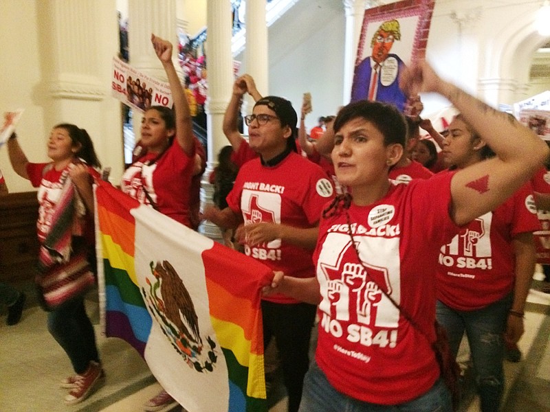 Demonstrators march in the Texas Capitol on Monday, protesting the state's newly passed anti-sanctuary cities bill in Austin. 
