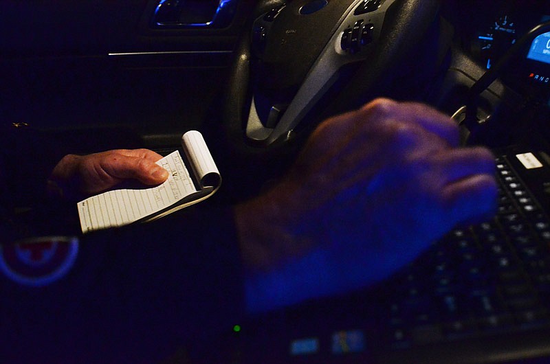 In this Jan. 1, 2016 file photo, a Jefferson City Police Department checks a note about an address during a traffic stop.
