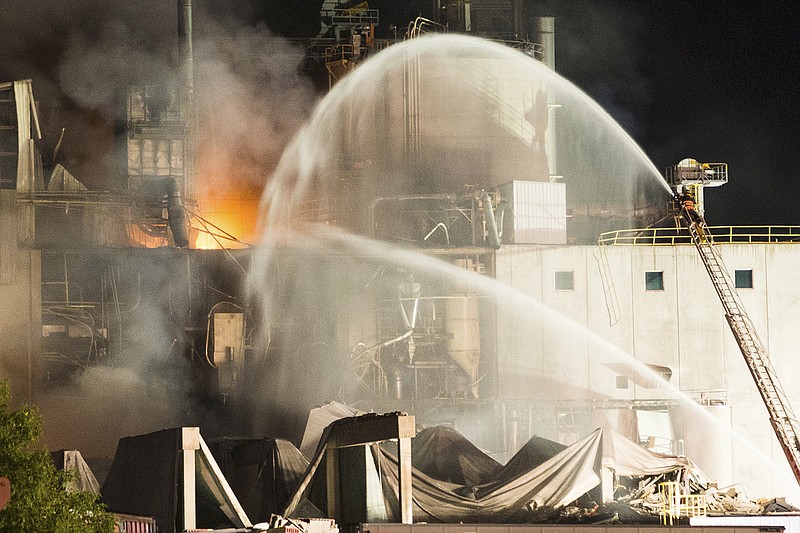 In this photo provided by Jeff Lange, Firefighters work at the scene Thursday following an explosion and fire at the Didion Milling plant in Cambria, Wisconsin. Recovery crews searched a mountain of debris following the fatal explosion late Wednesday at the corn mill plant, which injured about a dozen people and leveled parts of the sprawling facility in southern Wisconsin, authorities said.