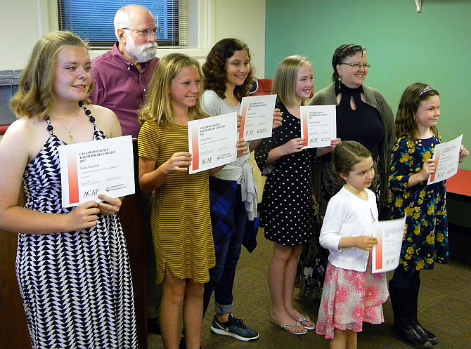 Callaway County Youth Poetry winners and the contest's judges pose for a picture with their awards during Thursday's ceremony at the Callaway County Library. From left are Haley Vanderiet, Judge Clarence Wolfshohl, Ashlyn Peters, Savannah Blair, Madison Hancock, Judge Denise Felt, Olivia Kerr and Alexandra Craighead. Winners had an opportunity to speak and share their poetry during the event.