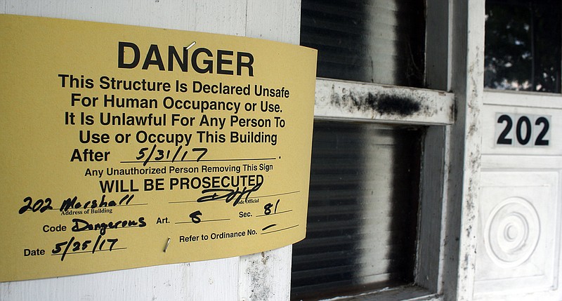 A danger sign hangs outside 202 Marshall St. The property was vacated due to code violations.