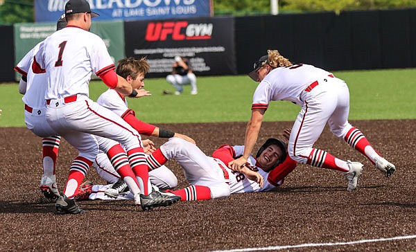 Jays players start a dog pile on Jacob Weirich (center) after he was hit by a pitch to force in the winning run in the bottom of the eighth inning of Saturday's Class 5 state championship game against Fort Zumwalt West at CarShield Field in O'Fallon. The Jays won 2-1 for their first state baseball championship since 1989, finishing the season with a 31-2 record.