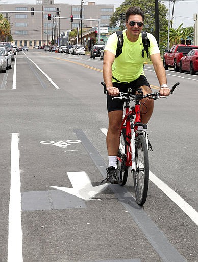 In a Friday, May 19, 2017 photo, Tim Tietjens, the planning and development director for Galveston and an avid cyclist, pedals south in the 19th Street bike lane, after a Bike to Work event at Hendley Green on The Strand. He is working with the Intermodal Transportation Committee to improve the city's biking plan. 