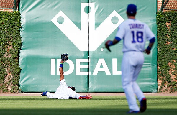 Cubs right fielder Jason Heyward catches a fly ball hit by Matt Carpenter of the Cardinals during the first inning of Sunday night's game in Chicago.