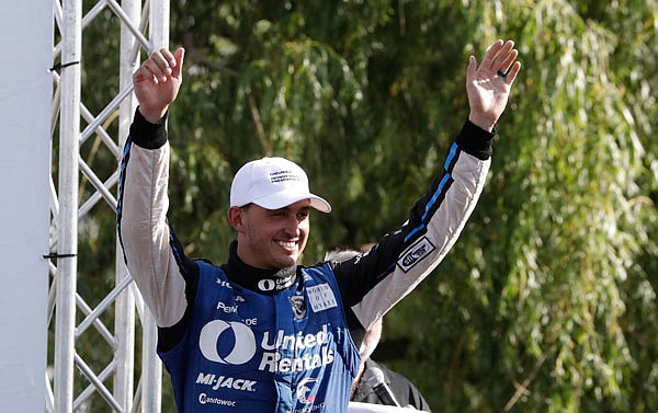 Graham Rahal acknowledges the fans as he approaches the winner's podium Sunday after the IndyCar Detroit Grand Prix in Detroit.