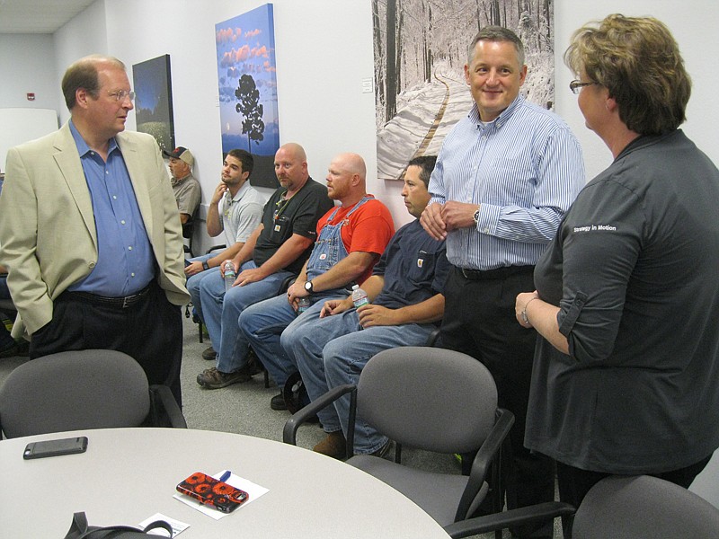 U.S. Rep. Bruce Westerman, center, of Arkansas' Fourth U.S. Congressional District, speaks with Charles M. Miller, executive director of the Arkansas Environmental Federation, left, and Tracy Long, vice president of marketing for Baldor Electric Company. Westerman came to Ashdown on Monday to receive the National Association of Manufactures Legislative Excellence Award.
