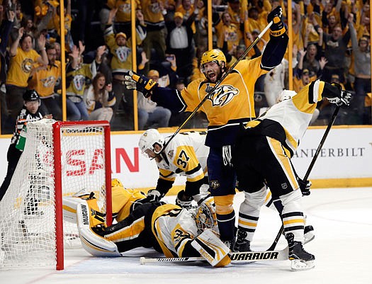 Craig Smith celebrates a goal by Predators teammate Calle Jarnkro as Penguins goalie Matt Murray falls on the ice during the first period of Monday night's game in Nashville, Tenn.