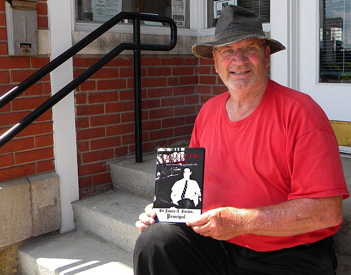 Local author Jim Barton shows off his recently self-published memoir about his time at Bland High School.