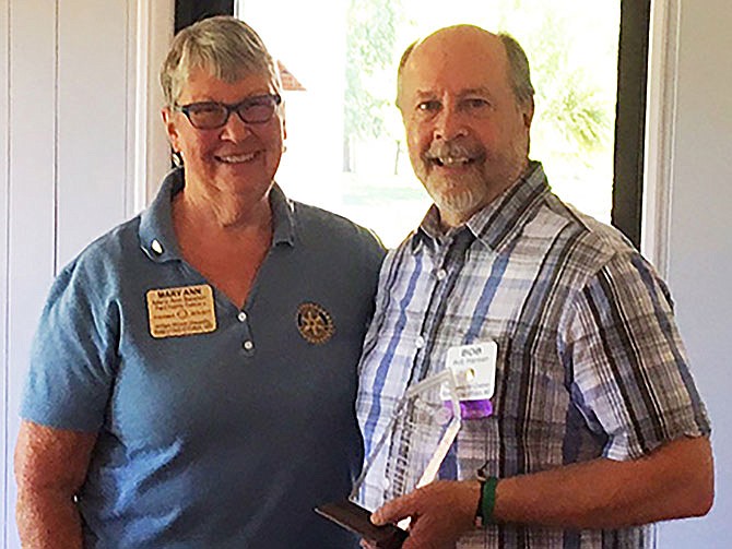 Bob Hansen receives the Raymond McCallister Rotarian of the Year award from Mary Ann Beahon, president of the Rotary Club of Fulton.