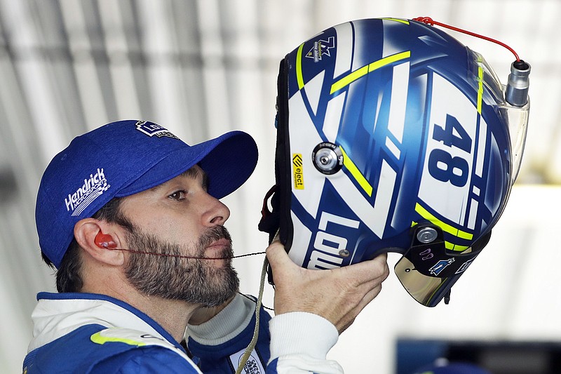Jimmie Johnson puts on his helmet before Friday's practice in Long Pond, Pa.