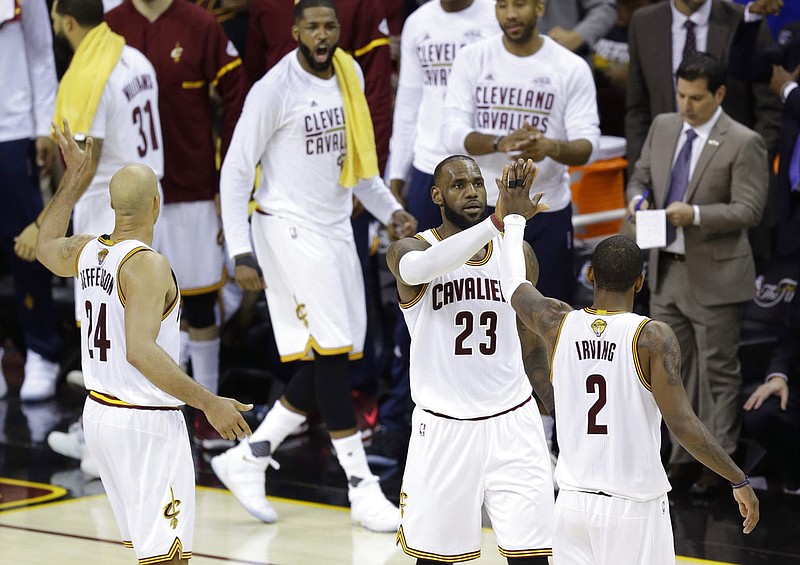 Cleveland Cavaliers forward LeBron James (23) and teammate Kyrie Irving (2) celebrate during the first half against the Golden State Warriors in Game 4 of basketball's NBA Finals in Cleveland, Friday, June 9, 2017.