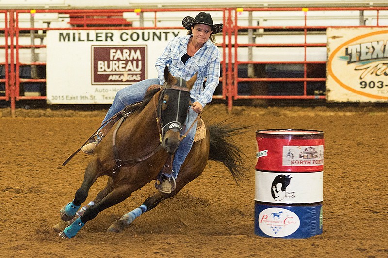 Brittiney Glass rides her horse Nikki be a Saint during the Runnin' WJ Barrel Race Friday at the Four States Fairgrounds. The race benefits Runnin' WJ Ranch, a local nonprofit that offers therapeutic horse riding. The event has grown substantially since beginning in 2008.