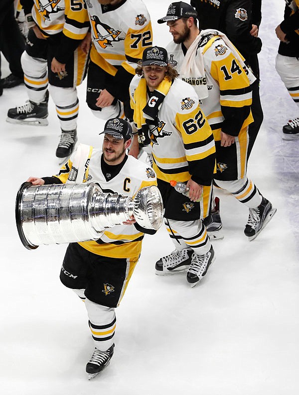 Sidney Crosby (87) of the Penguins celebrates with the Stanley Cup after defeating the Predators in Game 6 of the Stanley Cup Final on Sunday in Nashville.