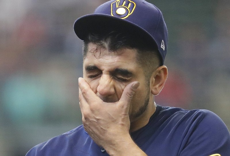 Milwaukee Brewers starting pitcher Matt Garza wipes his face after being taken out of the game during the sixth inning of a baseball game against the Toronto Blue Jays Wednesday, May 24, 2017, in Milwaukee. 