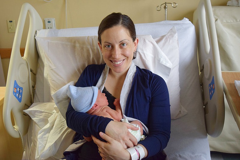 This Dec, 2016 photo provided by Tom Murray shows his wife, Sarah, and their newborn son, Owen, at the Bridgeport Hospital in Bridgeport, Conn. Sarah Murray is participating in research on whether it's safe for breast cancer survivors who want to get pregnant to temporarily suspend taking hormone-blocking drugs usually recommended for five years after initial treatment. She was only 29 and planning her wedding when her breast cancer was found in 2013.