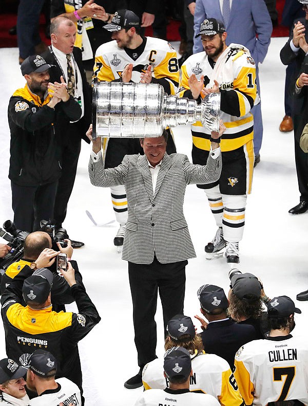 Penguins Owner Mario Lemieux hoists the Stanley Cup after defeating the Predators 2-0 in Game 6 of the Stanley Cup Final on Sunday in Nashville, Tenn.