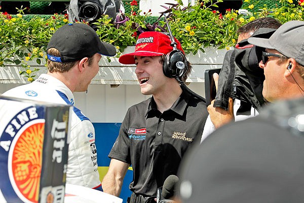 Ryan Blaney (center) interviews Brad Keselowski (left) in victory lane after Keselowski won the NASCAR Xfinity Series race Saturday in Long Pond, Pa.