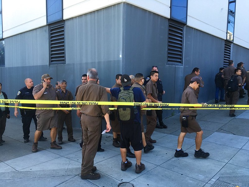 UPS workers gather outside after a reported shooting at a UPS warehouse and customer service center in San Francisco on Wednesday, June 14, 2017. San Francisco police confirmed a shooting at the facility in the Potrero Hill neighborhood but didn't release information on injuries or the shooter. 