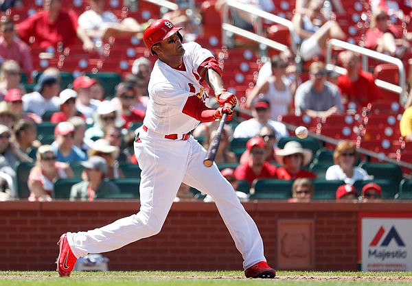 Cardinals right fielder Jose Martinez hits a sacrifice fly to score Yadier Molina during the sixth inning in the first game of Tuesday's doubleheader against the Brewers at Busch Stadium in St. Louis.