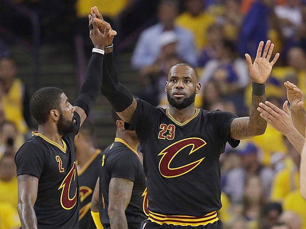 Cavaliers forward LeBron James reacts with guard Kyrie Irving after scoring during the first half of Game 5 of the NBA Finals on Monday in Oakland, Calif.