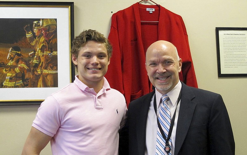 n this June 6, 2017 photo, Connor Carrow, 17, left, and Principal Cesar Marchioli pose inside Marchioli's office at Lancaster, High School in Lancaster, N.Y., the day after Marchioli gave Carrow a leadership award at the senior awards banquet. Carrow has been leading efforts at the school to replace the traditional class ranking system with a Latin honors cum laude system that recognizes all students who achieve a certain academic threshold. The ranking of students from No. 1 on down, based on grade point averages, has been fading steadily for about the past decade and about half of American schools no longer report class rank.