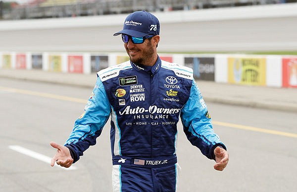 Martin Truex Jr. walks in the pit area before qualifying Friday, at Michigan International Speedway in Brooklyn, Mich. Truex will start second in Sunday's race.